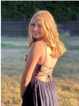 Junior Avery Jacobs In a blue dress in her yard. Photo taken prior to her homecoming dance.